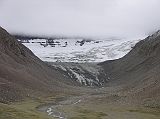 Tibet Kailash 09 Kora 01 Glacier between Avalokiteshvara and Manjushri We crossed the D�lma Chu by a bridge, and soon saw the north side of Shama Ri, east of Kailash, coming into cloudy view. This sharp jagged ridge represents the 18 Hells: 8 Cold, 8 Hot, and 2 Trial Hells. Its treacherous appearance serves as a sober reminder to pilgrims that hell exists and perhaps looks like this. A short truncated glacier with a small but distinct terminal, lateral, and medial moraines descends from the rocky eastern arm of the north face of Kailash, down through the P�lung Valley between Avalokiteshvara and Manjushri.